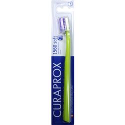 Eine grüne Zahnbürste in einer blauen Verpackung.